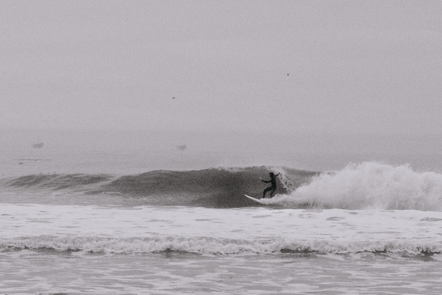 Surfer riding along a breaking wave